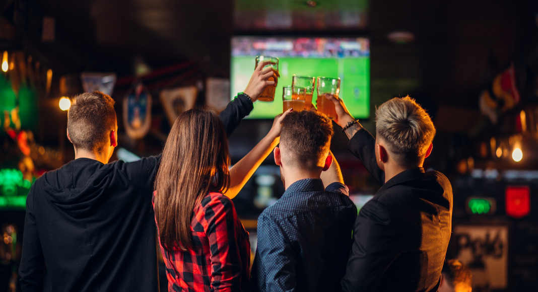 where to watch football around charleston: a family cheers while watching a game at a restaurant