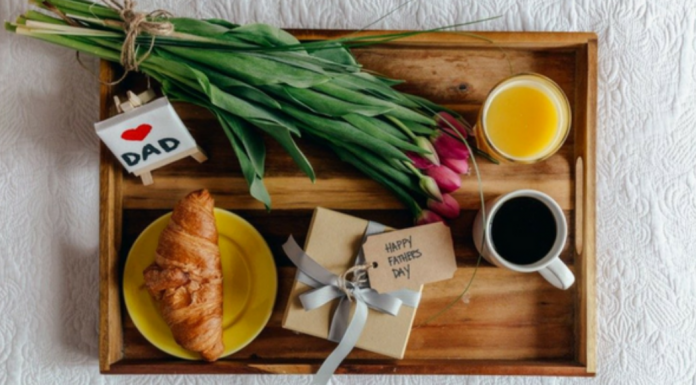 father's day gifts: a breakfast tray with sleek flower bouquet, and small gift included.
