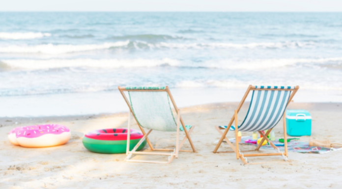 Practice the Pause: two beach chairs face the ocean waves with beach toys scattered around.