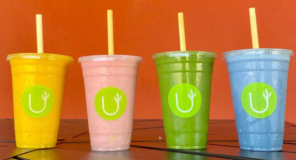 cold treats: Smoothies of different colors in to-go cups.