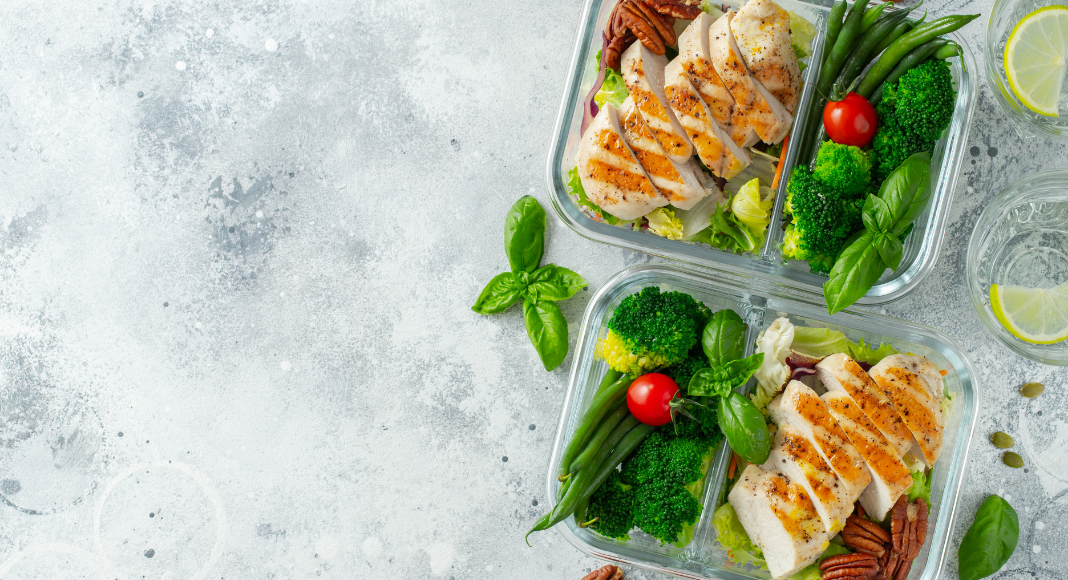 Summer lunch with grilled chicken and veggies packed in to-go containers.