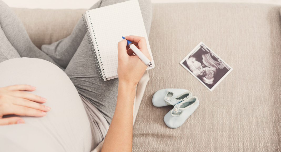 pregnant woman writing births