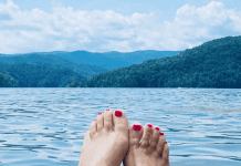 A photo of a woman's toes, overlooking lake jocassee.