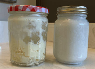 homemade beauty products: sitting on a bathroom countertop are two glass jars full of white and off-white products.
