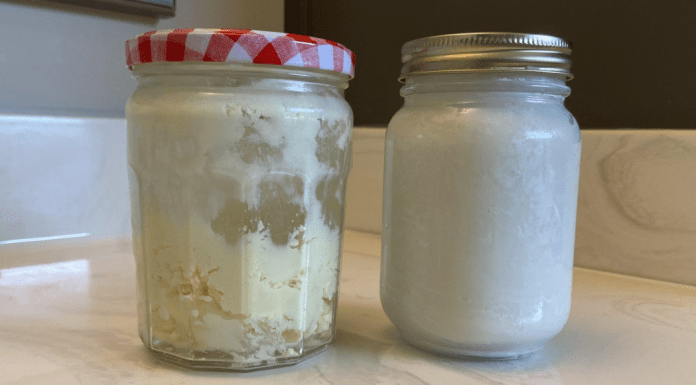 homemade beauty products: sitting on a bathroom countertop are two glass jars full of white and off-white products.
