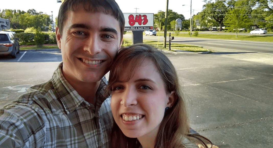 A young couple smiles outside, with the 843 Korean BBQ & Sushi House sign in the background.