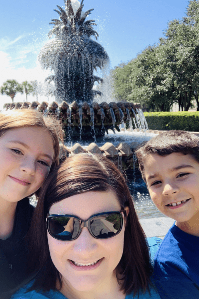 Curing summer boredom: a mom with her two kids in front of pineapple fountain.