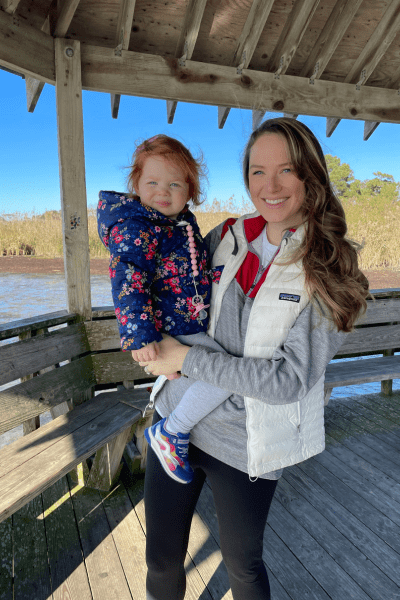 Raising a Child Who Is Just Like You: a mom holds her toddler daughter under a gazebo