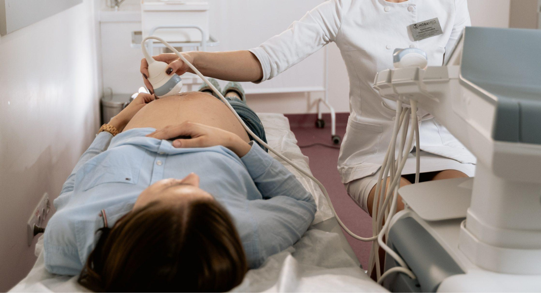 PCOS: a woman receives an ultrasound on her abdomen.