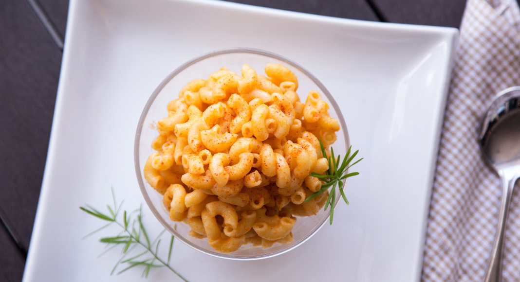 A bowl of mac and cheese on a plate.