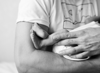 Father's Day Poem: a father holds a newborn baby in his arms.