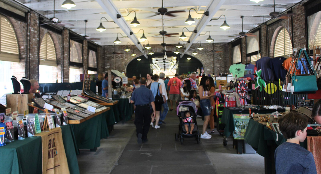 A view of booths and shoppers on the inside of the Charleston City Market.