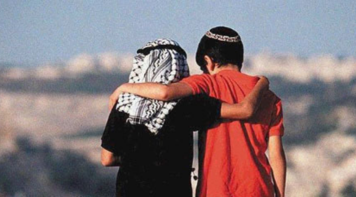 two older children hug in Palestine
