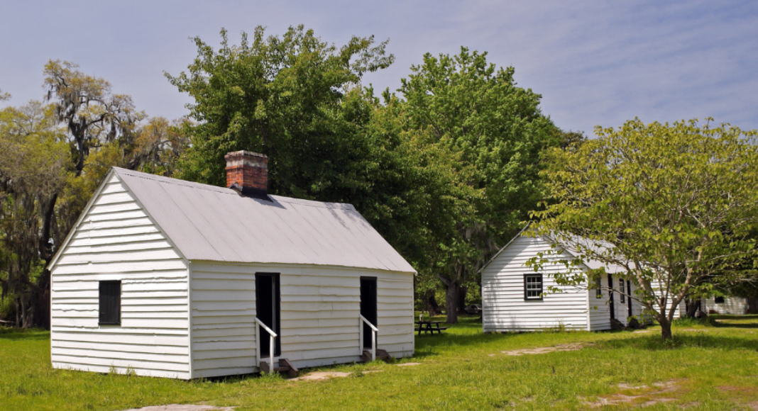 Small white houses that were used as living quarters for enslaved workers at Magnolia Plantation.