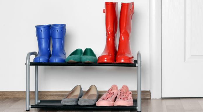 A shoe rack as a home organization tool holding various pairs of shoes.