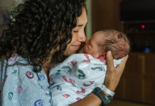 Childbirth Recovery: a mother nuzzles her newborn baby.