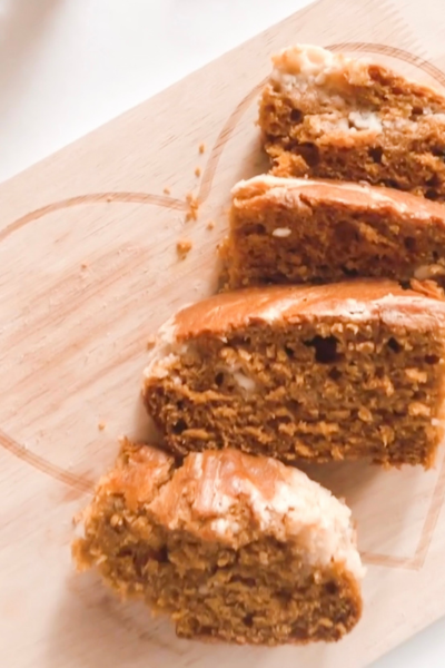easy holiday recipes: cream cheese pumpkin loaf sliced on a cutting board