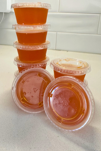 Fall cocktails: orange jell-o shots stacked in small plastic containers