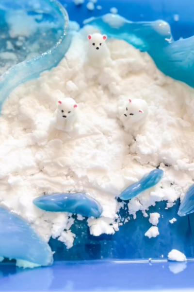 holiday crafts: play snow in a blue bin with polar bear toys