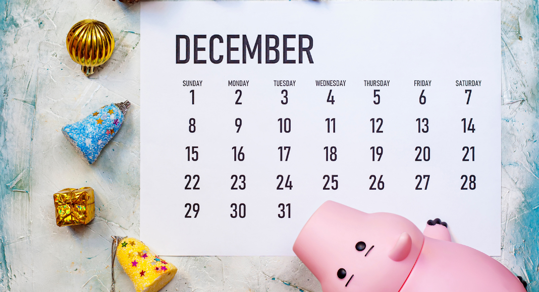 holiday spending plan: a december calendar with a piggy bank and tree ornaments surrounding