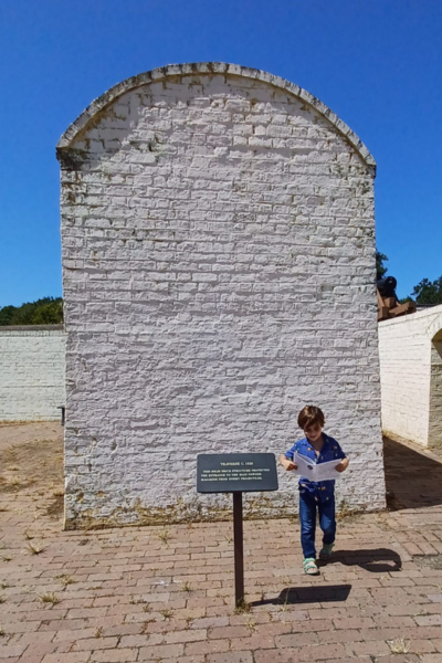 A young boy reading a map in front of a monument at Fort Moultrie.
