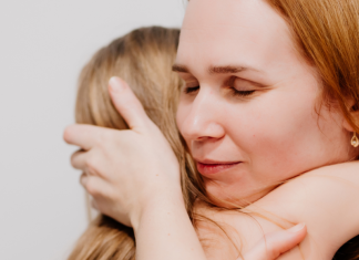 a mother hugs her daughter after receiving disappointing news