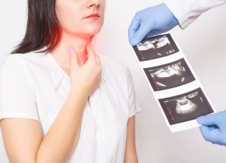a woman holds her neck, while a doctor's hands holds a sheet of thyroid ultrasound images