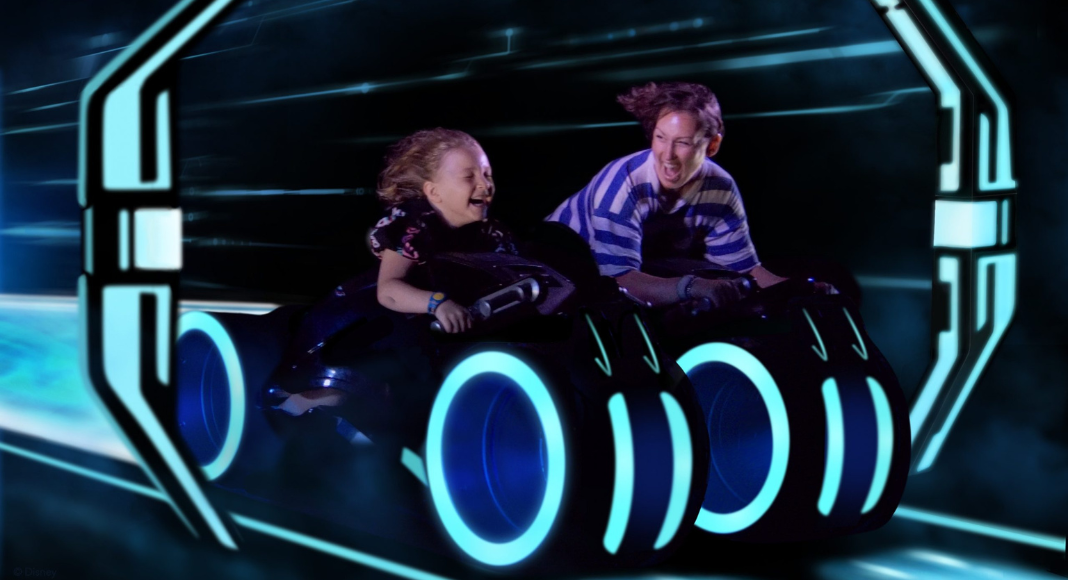 Solo trips with kids: a mom and her child are on a ride together at Disney world.