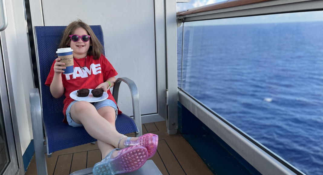 Solo trips with kids: A preteen girl relaxes on a cruise ship balcony.