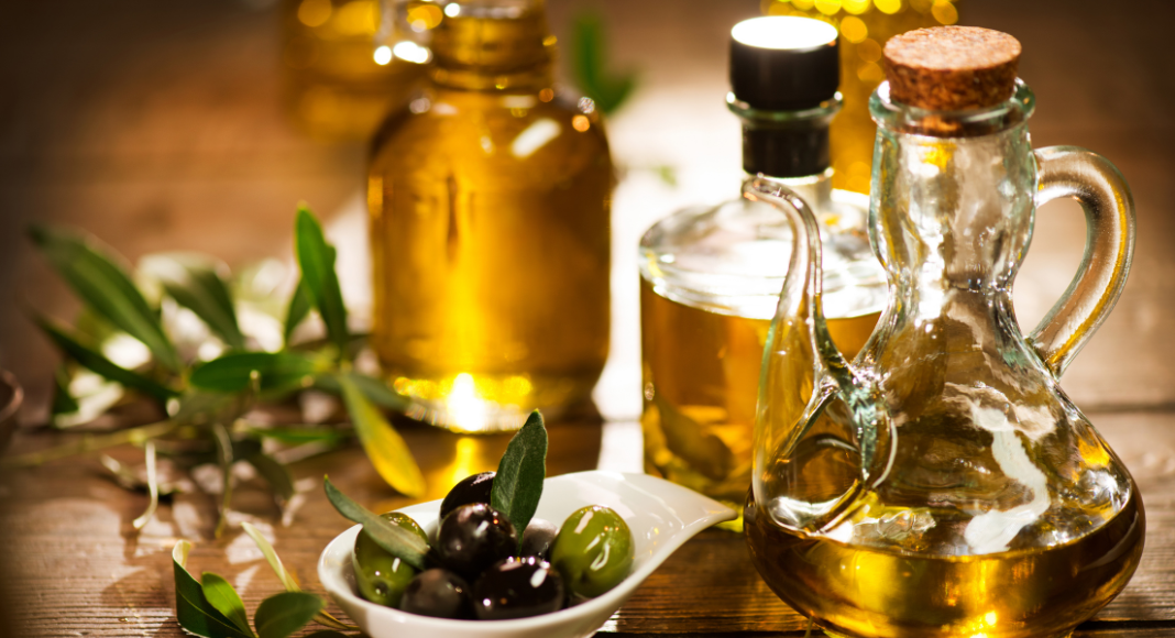 winter home spa:: olive oil in glass jars with a small bowl of olives.