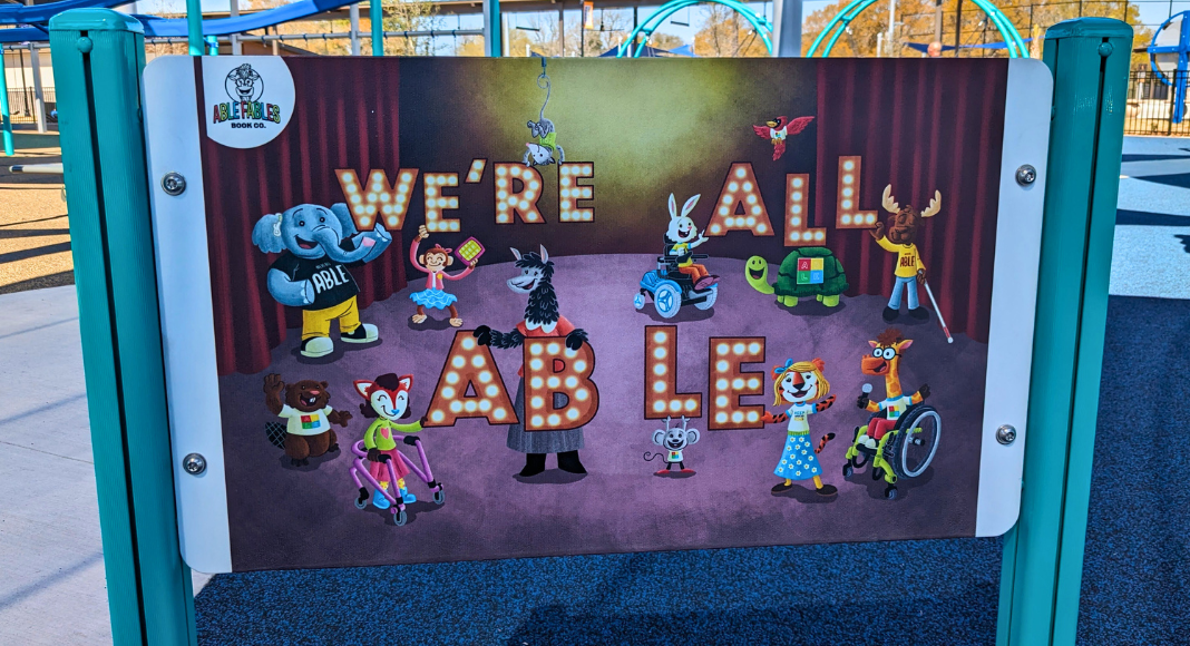 A decorative sign with animals, some using wheelchairs and other equipment. It says, "We're all able."