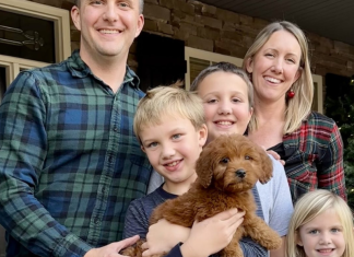 Katie Guffey with her husband, three children, and puppy.