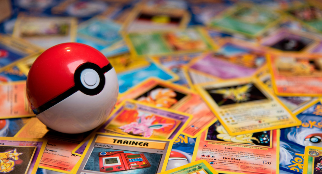 National Pokémon Day: A Pokéball sits on top of a messy pile of Pokémon cards.