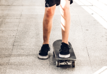 A view of a child's legs skateboarding