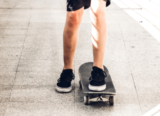 A view of a child's legs skateboarding