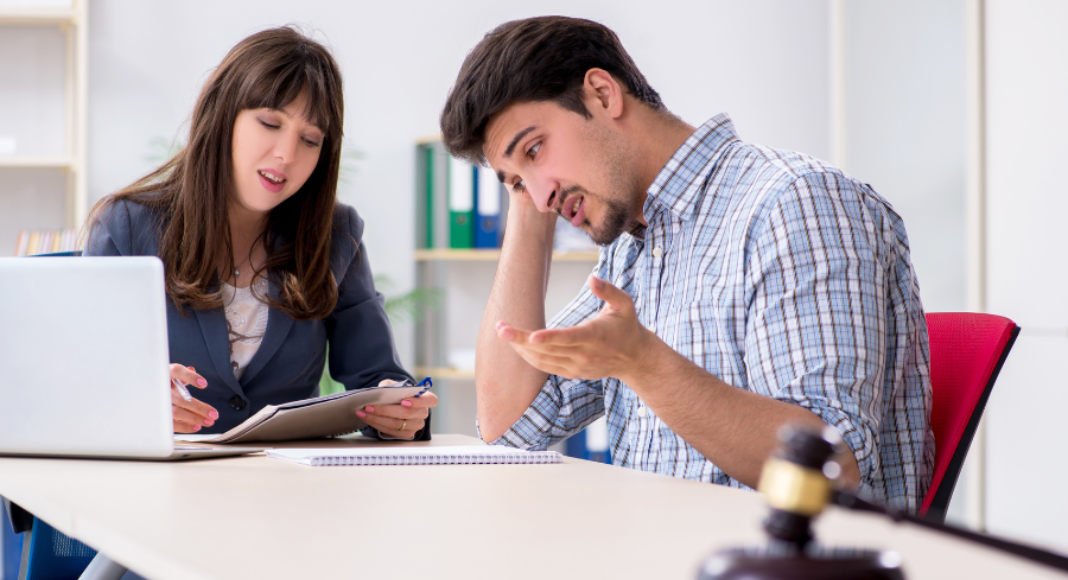 Types of divorce: A man and woman sit at a table having a discussion.