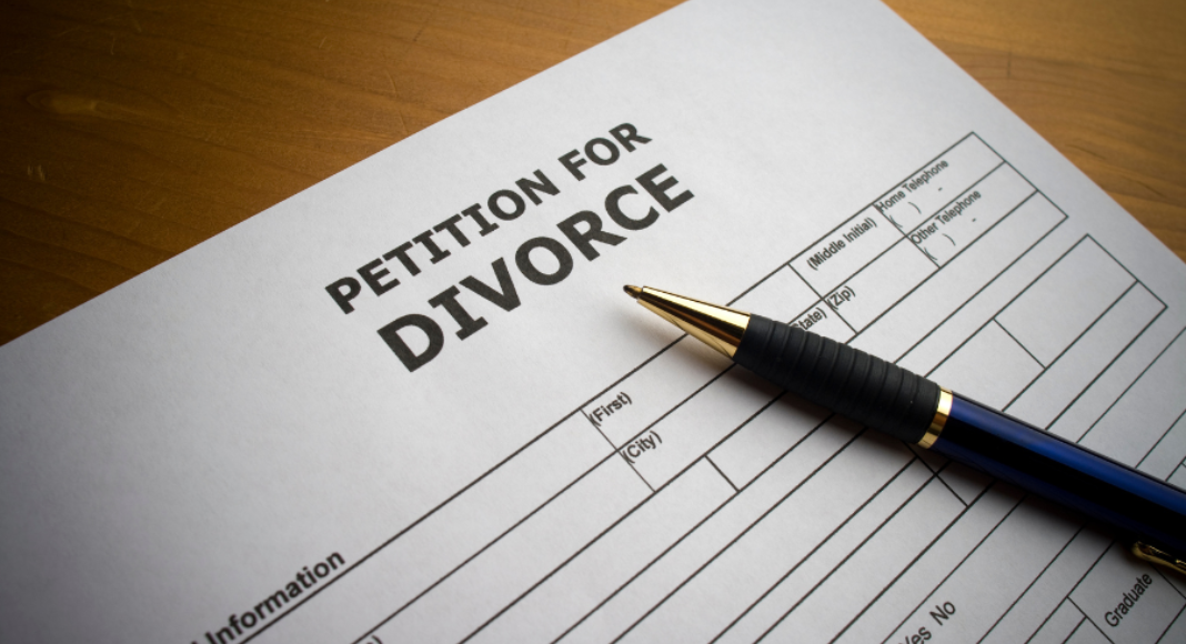 Divorce process: a form titled "Petition for Divorce" lays on a table with a pen.