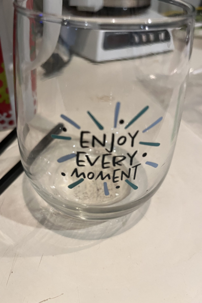 A glass mug states, "Enjoy Every Moment."