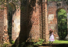hidden adventures: a toddler girl walks among old church ruins.