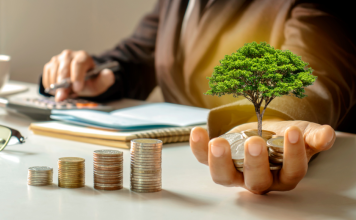 Investing money: a woman holds coins that have an imaginary tree sprouting from them.