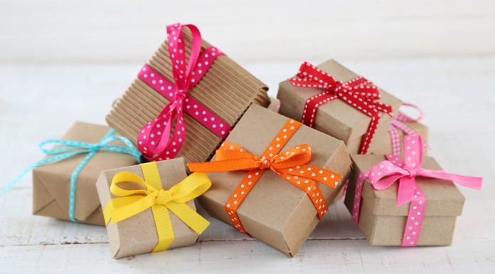 teacher appreciation week gifts: A pile of small boxes wrapped in brown paper and colorful ribbon.