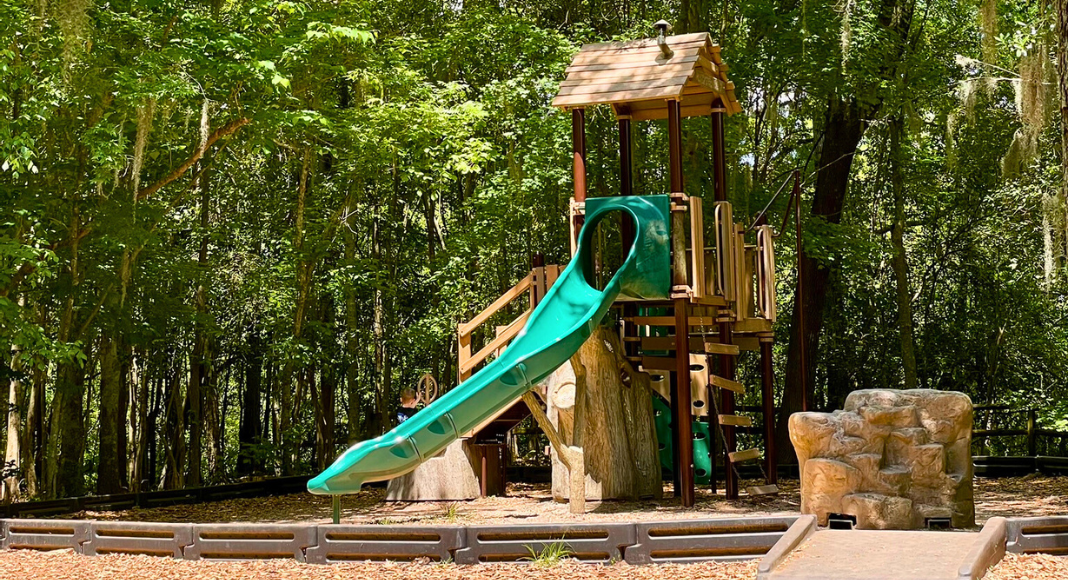 A wooden playground with slide at Old Santee Canal Park.
